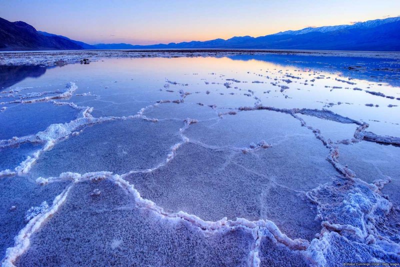 Evening Salt Field Work with Colorful Sky at Hon Khoi Salt workers walking on salt pans with colorful evening sky at Hon Khoi Salt Fields