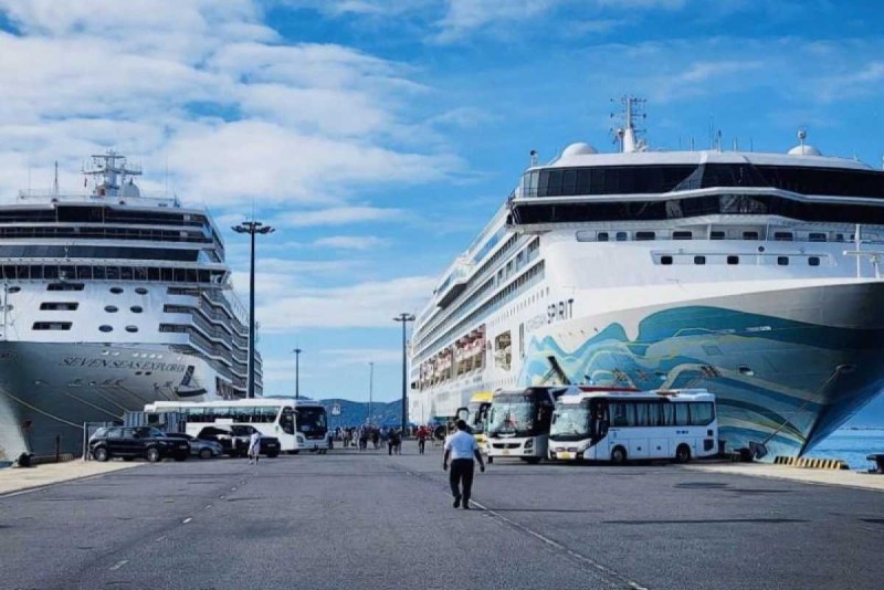 Cruise port scene with buses transferring passengers from Nha Trang City Centre to Cau Da Port Busy port area with buses and cruise ships for transfers from Nha Trang City Centre to Cau Da Port