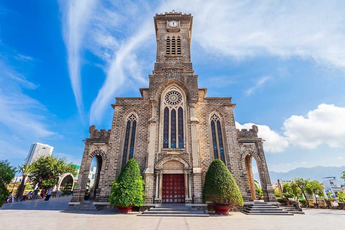 Front view of Nha Trang Cathedral with its Gothic architecture under a clear blue sky, part of the nha trang half day tour.