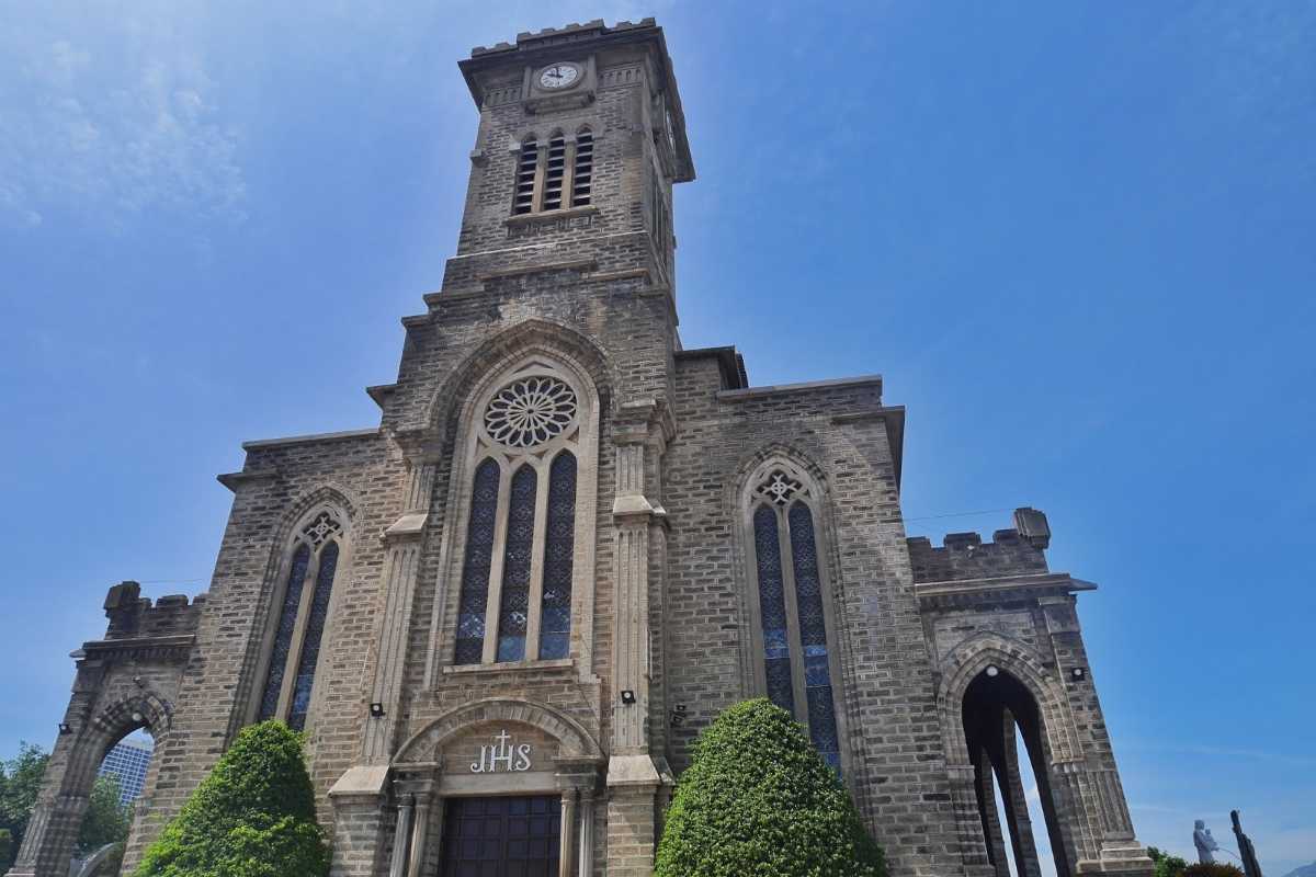 Front view of the Stone Church in Nha Trang under a clear blue sky during the cultural day trip.